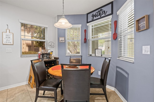 tiled dining room with baseboards and a wealth of natural light