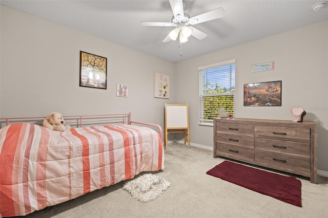carpeted bedroom with baseboards and ceiling fan