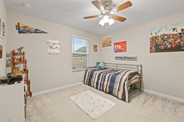 bedroom with baseboards, carpet flooring, and ceiling fan