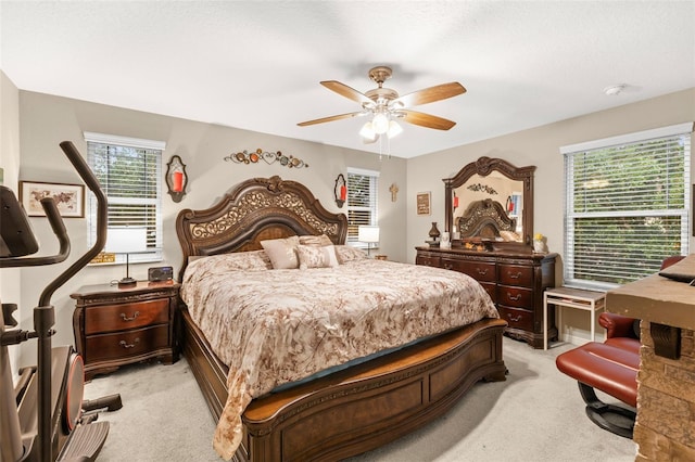 bedroom with ceiling fan and light carpet