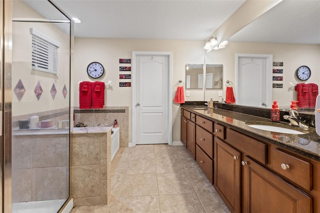 bathroom featuring a sink, a bath, tile patterned flooring, and double vanity