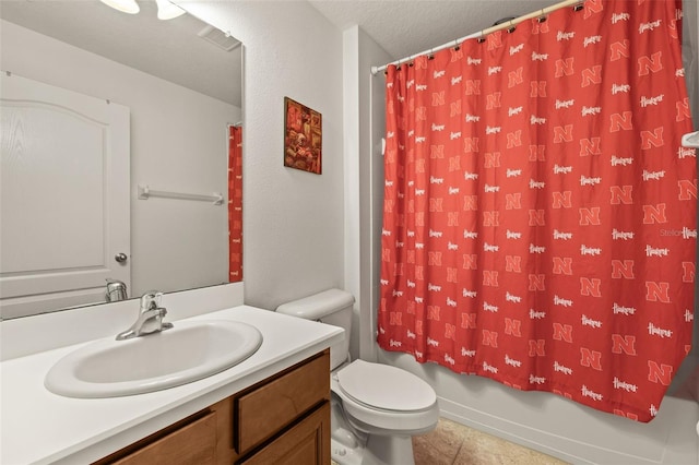 bathroom featuring vanity, tile patterned flooring, shower / bath combo with shower curtain, toilet, and a textured ceiling
