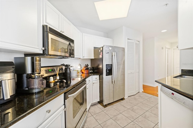 700 S Harbour Island Blvd Unit 342, Tampa, FL 33602 - kitchen featuring stainless steel appliances, white cabinetry, light tile patterned floors, dark stone countertops, and recessed lighting