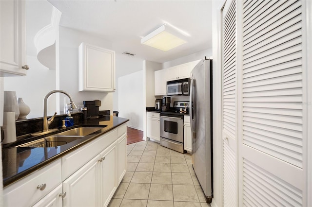 700 S Harbour Island Blvd Unit 342, Tampa, FL 33602 - kitchen featuring stainless steel appliances, a sink, dark countertops, and white cabinetry