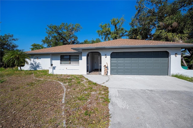 2167 Corfell St, Port Charlotte, FL 33948 - ranch-style house with stucco siding, concrete driveway, and an attached garage