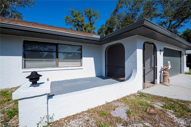 2167 Corfell St, Port Charlotte, FL 33948 - view of front of house featuring stucco siding, driveway, and an attached garage