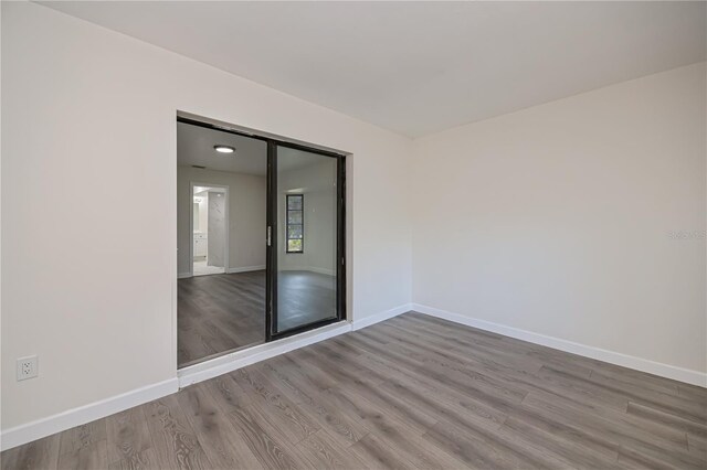 2167 Corfell St, Port Charlotte, FL 33948 - empty room with wood finished floors and baseboards
