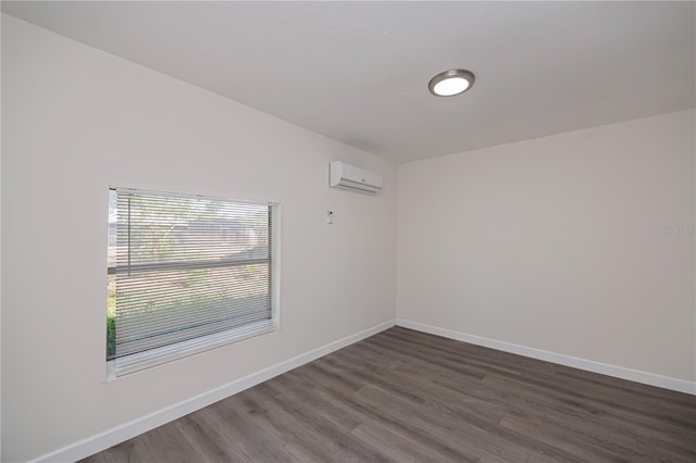 2167 Corfell St, Port Charlotte, FL 33948 - unfurnished room with a wall mounted air conditioner, dark wood-style flooring, and baseboards
