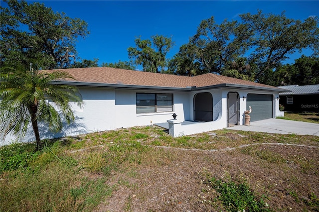 2167 Corfell St, Port Charlotte, FL 33948 - view of front facade featuring stucco siding, an attached garage, and driveway