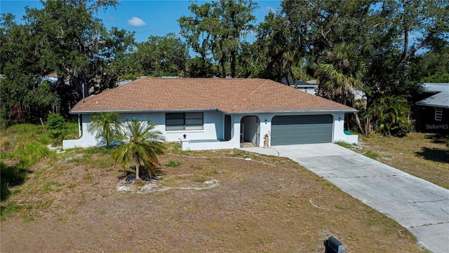 2167 Corfell St, Port Charlotte, FL 33948 - ranch-style house featuring stucco siding, an attached garage, driveway, and a front yard