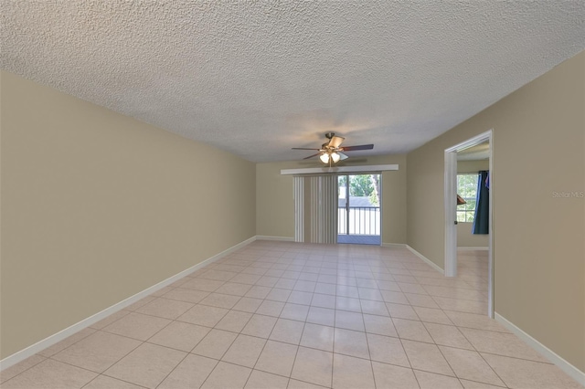 330 Promenade Dr Unit 206, Dunedin, FL 34698 - empty room with light tile patterned floors, baseboards, ceiling fan, and a textured ceiling