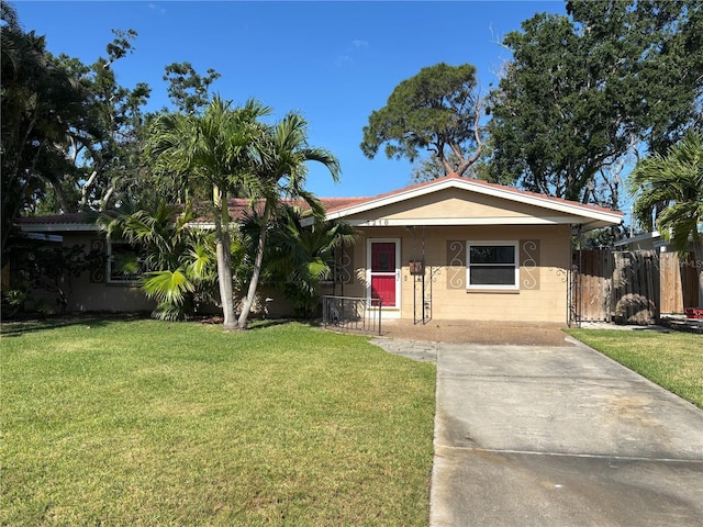 4218 Carson St NE, Saint Petersburg, FL 33703 - view of front of property with covered porch, a front yard, concrete driveway, and concrete block siding