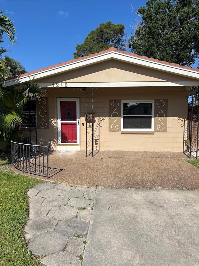4218 Carson St NE, Saint Petersburg, FL 33703 - view of front of house featuring covered porch and concrete block siding
