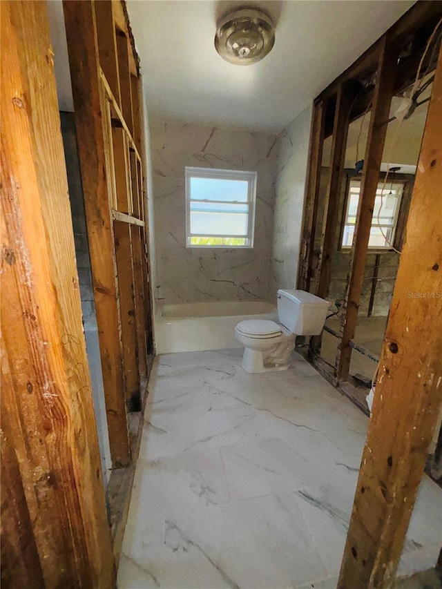 4218 Carson St NE, Saint Petersburg, FL 33703 - bathroom with marble finish floor, walk in shower, and toilet