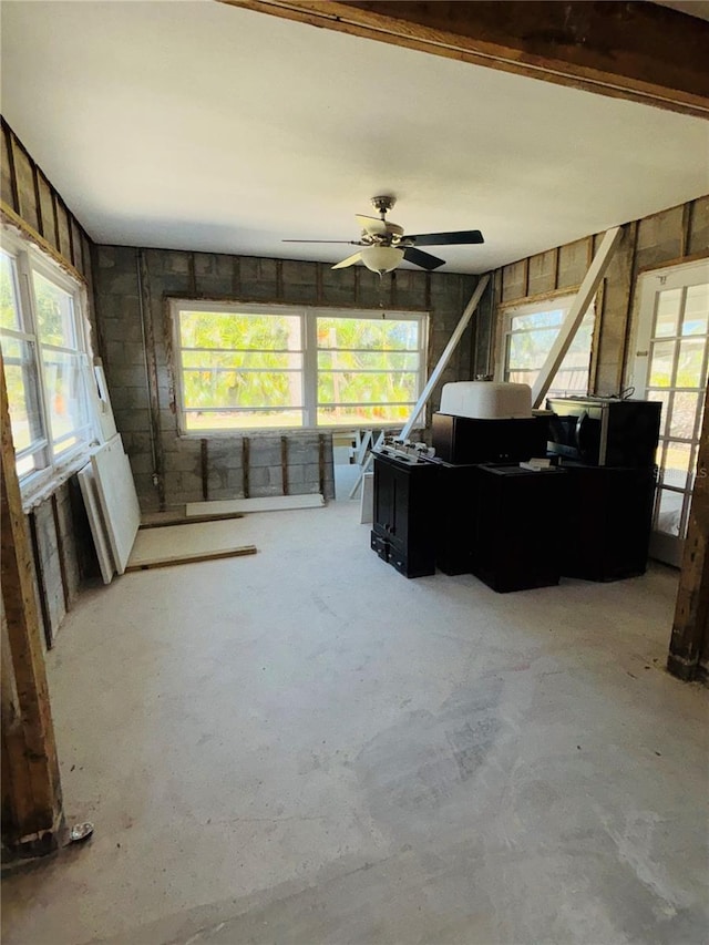 4218 Carson St NE, Saint Petersburg, FL 33703 - living room with a healthy amount of sunlight, ceiling fan, and unfinished concrete flooring