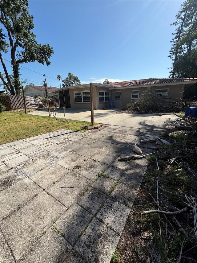 4218 Carson St NE, Saint Petersburg, FL 33703 - back of property with a lawn, a patio area, and fence