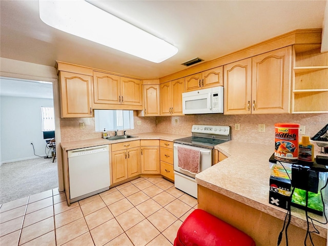 kitchen with light brown cabinetry, a sink, white appliances, light countertops, and visible vents