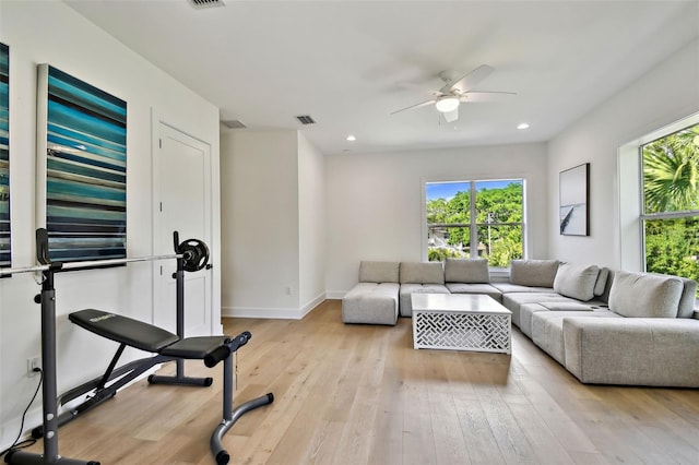 living area featuring plenty of natural light, ceiling fan, light wood-style floors, recessed lighting, and baseboards