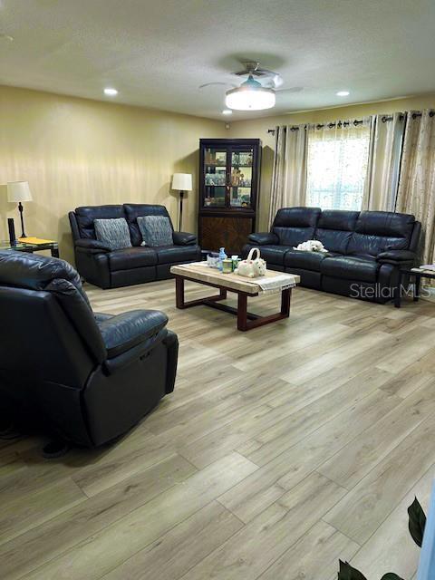 3086 Pointer Dr, Palm Harbor, FL 34683 - living room featuring light wood-type flooring, a ceiling fan, and recessed lighting