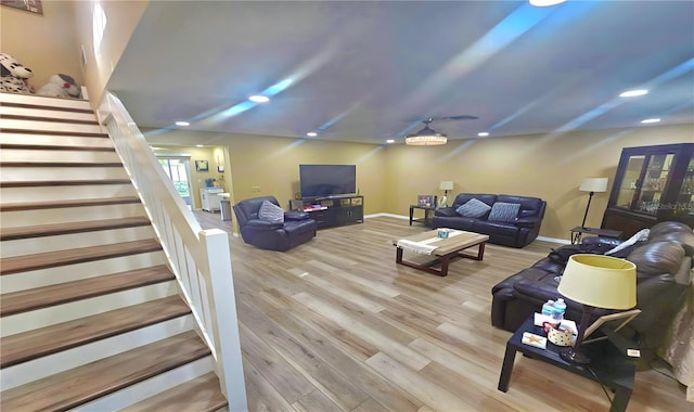 3086 Pointer Dr, Palm Harbor, FL 34683 - living area featuring stairs, wood finished floors, baseboards, and recessed lighting