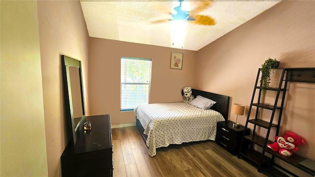 3086 Pointer Dr, Palm Harbor, FL 34683 - bedroom with wood finished floors, baseboards, vaulted ceiling, and a ceiling fan