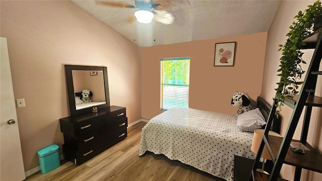 3086 Pointer Dr, Palm Harbor, FL 34683 - bedroom featuring lofted ceiling, light wood-type flooring, a textured ceiling, baseboards, and a ceiling fan
