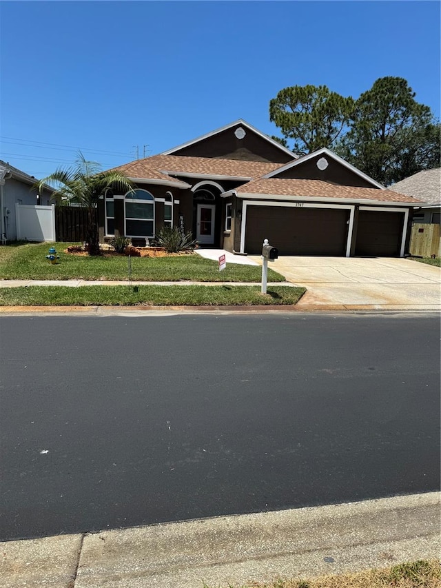 1747 Wood Brook St, Tarpon Springs, FL 34689 - single story home with a garage, a shingled roof, and driveway