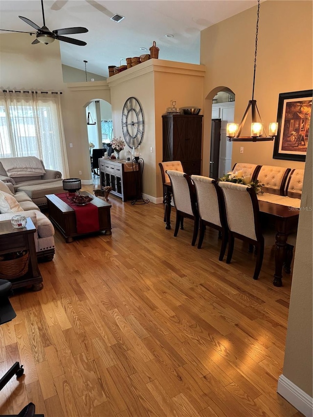 1747 Wood Brook St, Tarpon Springs, FL 34689 - living room with arched walkways, high vaulted ceiling, light wood-style floors, a ceiling fan, and baseboards