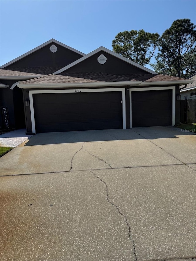 1747 Wood Brook St, Tarpon Springs, FL 34689 - single story home with driveway, a garage, and a shingled roof