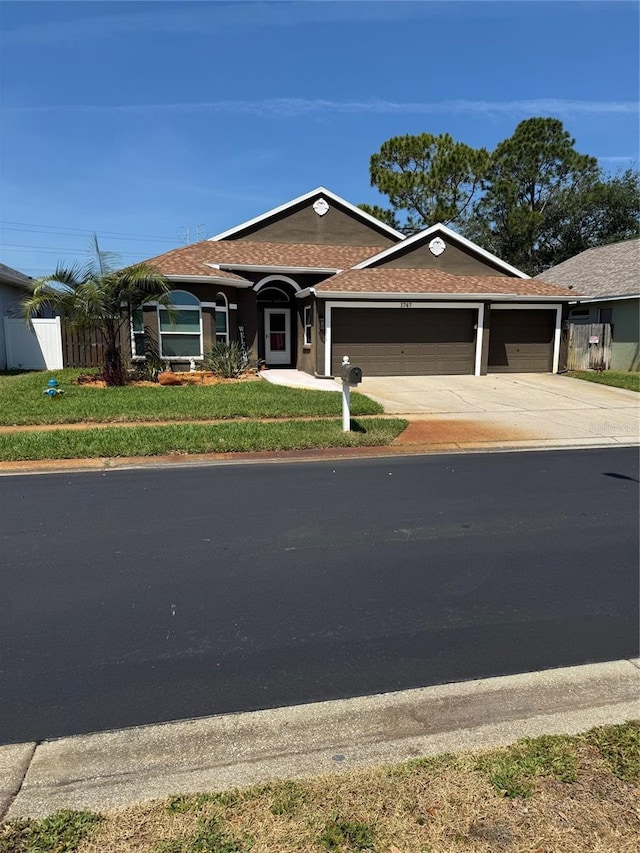 1747 Wood Brook St, Tarpon Springs, FL 34689 - ranch-style house featuring an attached garage, concrete driveway, and a shingled roof