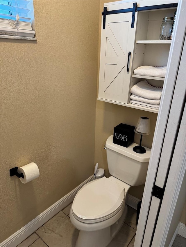 1747 Wood Brook St, Tarpon Springs, FL 34689 - bathroom featuring baseboards, toilet, and tile patterned floors