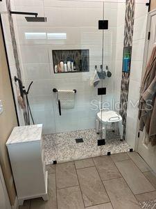 1747 Wood Brook St, Tarpon Springs, FL 34689 - bathroom featuring a stall shower and tile patterned floors