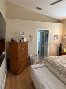 1747 Wood Brook St, Tarpon Springs, FL 34689 - bedroom featuring vaulted ceiling, light wood finished floors, and baseboards