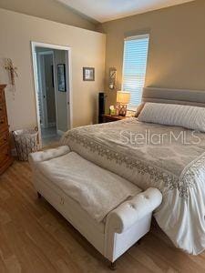 1747 Wood Brook St, Tarpon Springs, FL 34689 - bedroom with wood finished floors and lofted ceiling