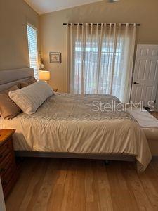 1747 Wood Brook St, Tarpon Springs, FL 34689 - bedroom featuring wood finished floors and vaulted ceiling