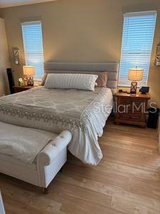 1747 Wood Brook St, Tarpon Springs, FL 34689 - bedroom featuring multiple windows and wood finished floors