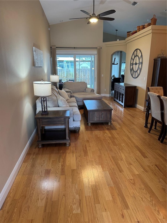 1747 Wood Brook St, Tarpon Springs, FL 34689 - living room featuring a ceiling fan, light wood-style floors, baseboards, arched walkways, and high vaulted ceiling