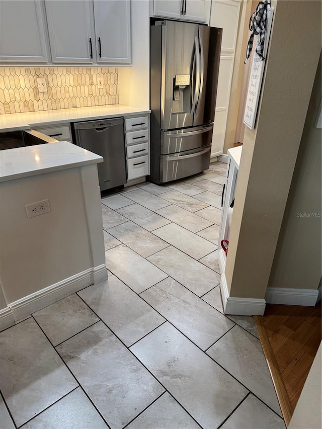 1747 Wood Brook St, Tarpon Springs, FL 34689 - kitchen with stainless steel appliances, tasteful backsplash, light countertops, and baseboards