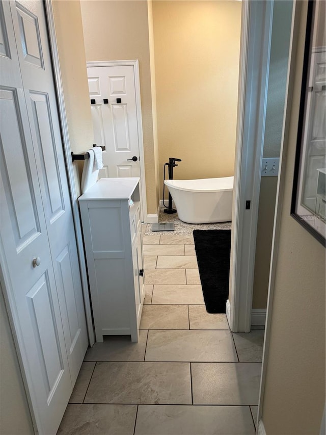 1747 Wood Brook St, Tarpon Springs, FL 34689 - bathroom with a soaking tub, baseboards, and vanity