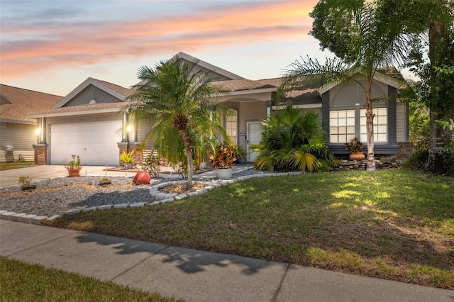 view of front facade with a garage, a front lawn, and driveway