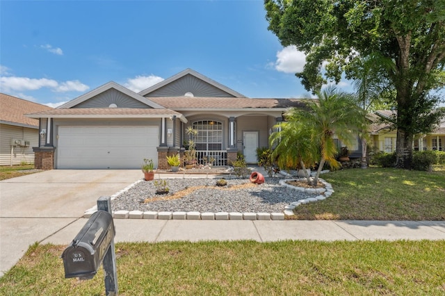 ranch-style house featuring concrete driveway, a porch, a front yard, and a garage