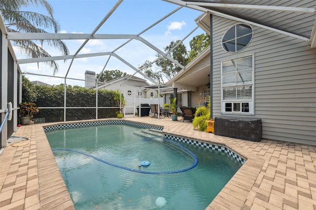 view of swimming pool with a fenced in pool, glass enclosure, a patio area, and a jacuzzi