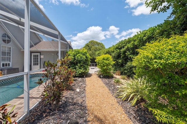 view of yard featuring a lanai and an outdoor pool