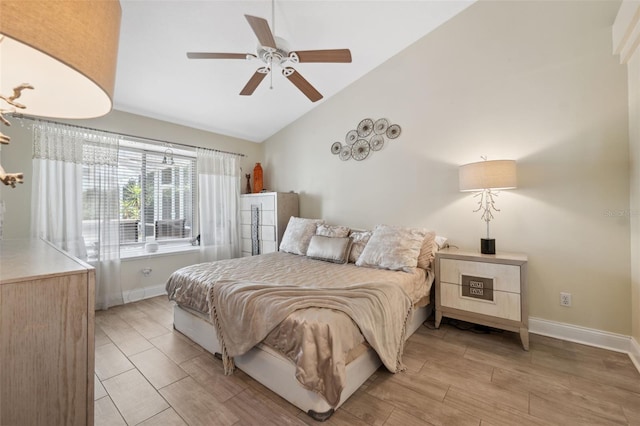 bedroom featuring baseboards, ceiling fan, light wood-type flooring, and lofted ceiling