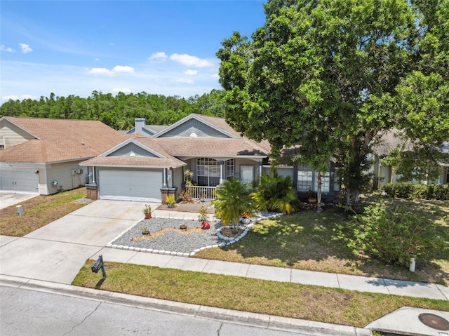 ranch-style house with a porch, an attached garage, concrete driveway, and a front lawn