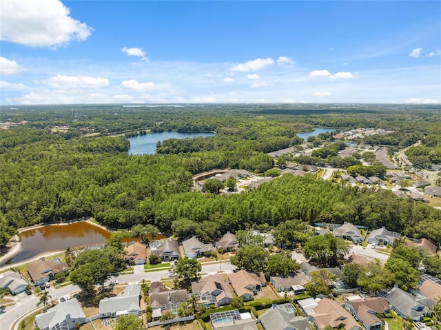 aerial view featuring a water view, a residential view, and a wooded view