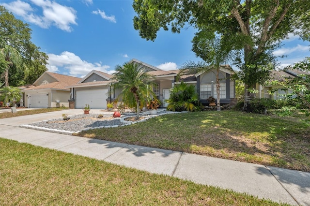 view of front of house with concrete driveway, an attached garage, and a front lawn