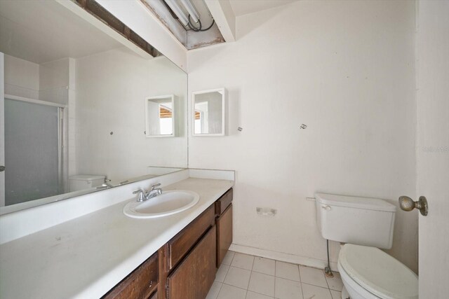 829 E Gulf Blvd Unit 107, Indian Rocks Beach, FL 33785 - full bathroom with toilet, vanity, a shower stall, baseboards, and tile patterned flooring