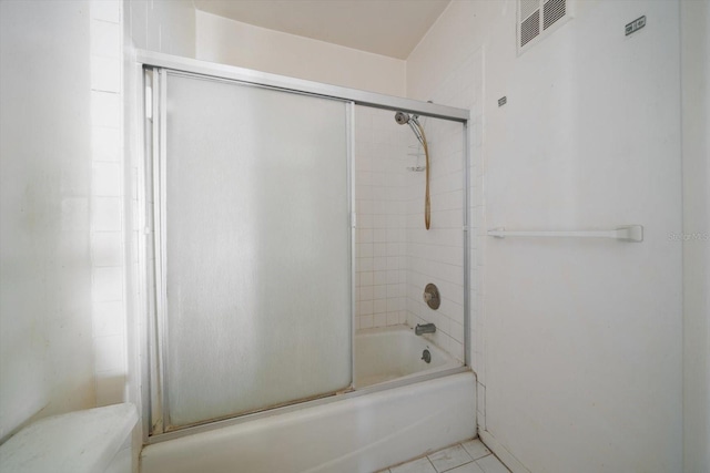 829 E Gulf Blvd Unit 107, Indian Rocks Beach, FL 33785 - full bathroom featuring combined bath / shower with glass door, tile patterned floors, and toilet