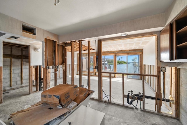 829 E Gulf Blvd Unit 107, Indian Rocks Beach, FL 33785 - misc room with a water view and concrete floors